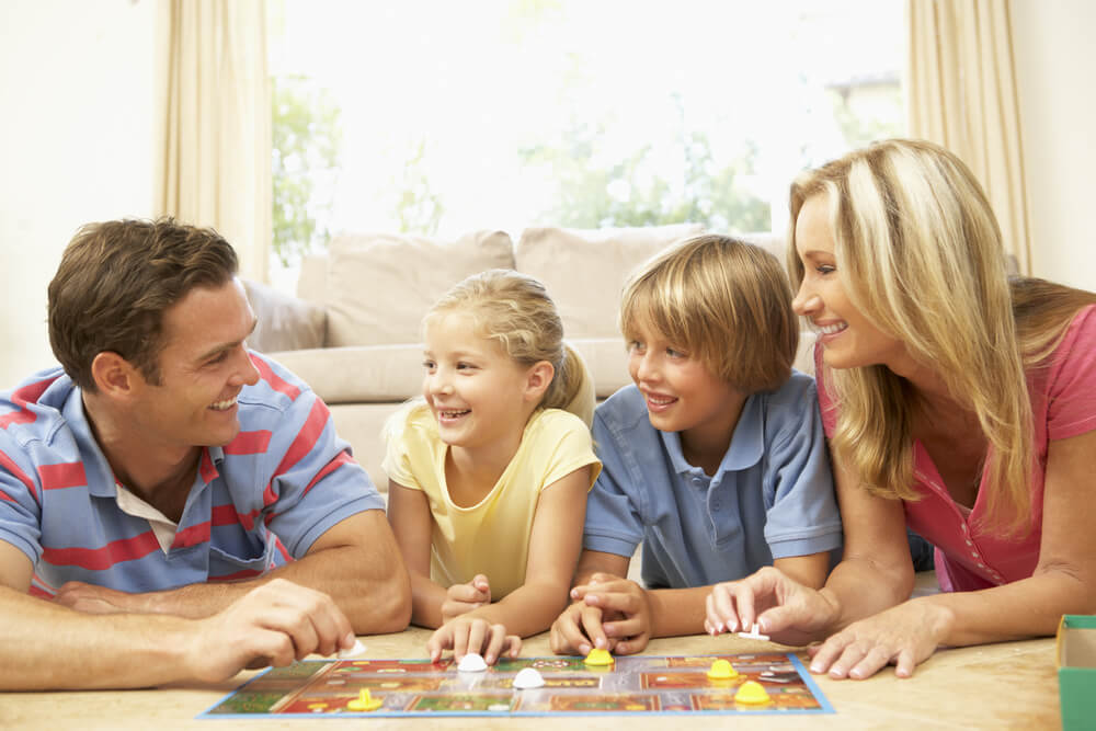 Family playing board game together