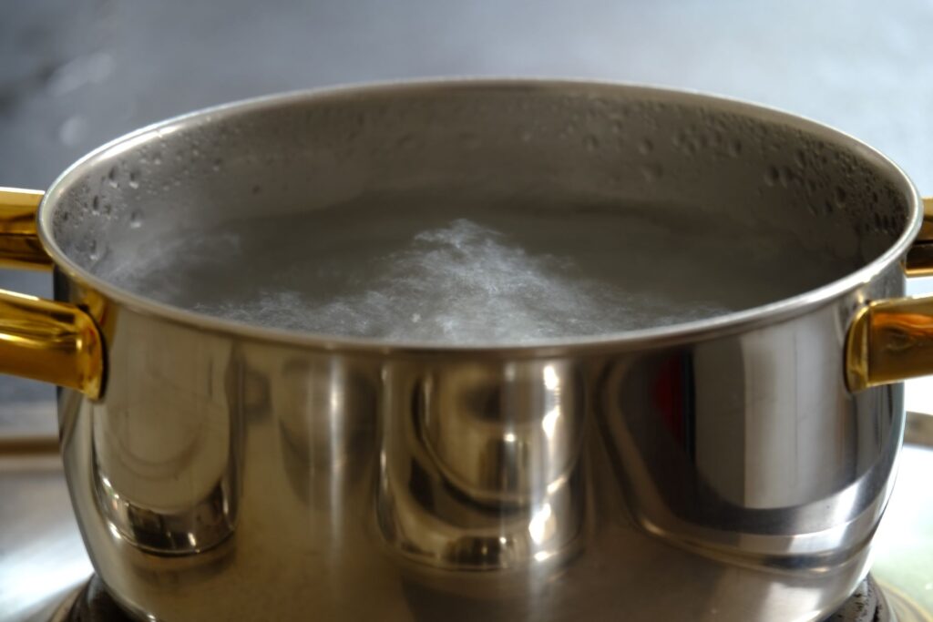 A large pot of boiling water on a stove.