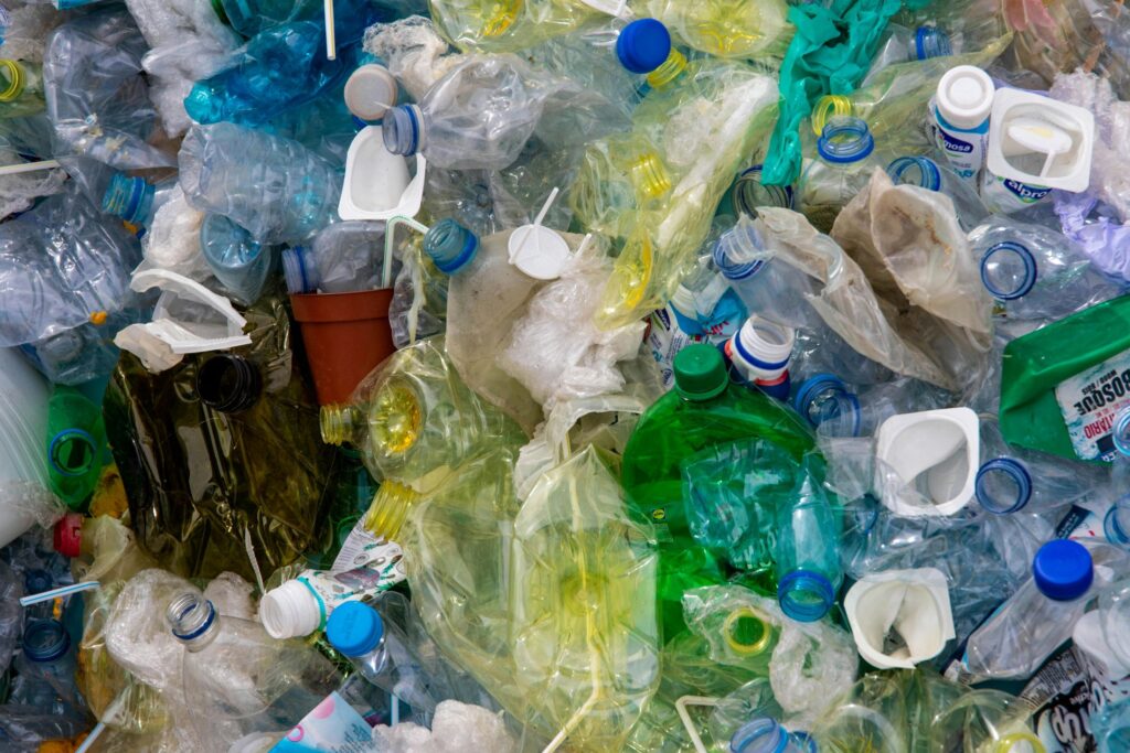 A pile of plastic trash accumulates on the beach.